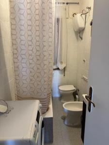 a bathroom with two toilets and a sink at Happy Rock in Formia