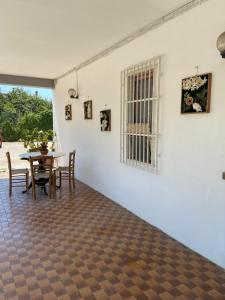 a dining room with a table and chairs and a white wall at Happy Rock in Formia