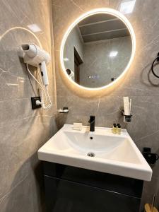 a bathroom with a white sink and a mirror at River Light-Guest House in Alaverdi