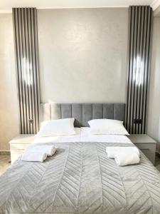 a bedroom with a large bed with two towels on it at River Light-Guest House in Alaverdi
