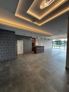 a large room with a large tile floor and a ceiling at Lake&Chill Residence in Palić