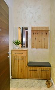 a bathroom with a wooden bench and a mirror at Lake&Chill Residence in Palić +14 photos