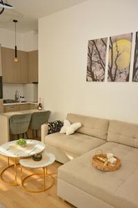 a living room with a couch and a table at Lake&Chill Residence in Palić