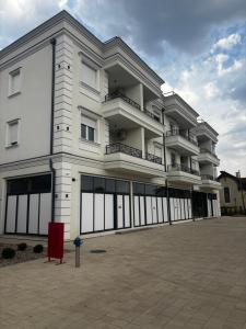 a large white building with a lot of windows at Lake&Chill Residence in Palić