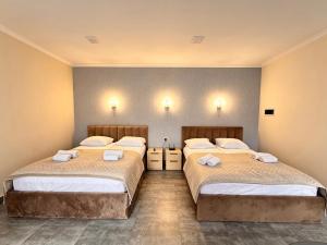 two beds in a room with at River Light-Guest House in Alaverdi +7 photos