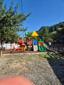 a childrens playground with a colorful play equipment at Vila Dascalita in Moieciu de Sus