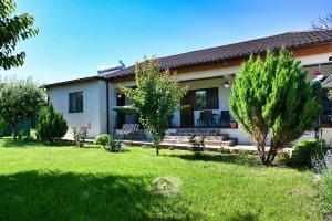 a house with a lawn in front of it at Casa EBO in 2 Mai