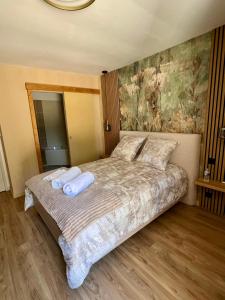 a bedroom with a bed with two pillows on it at L'Escale d'Armorique 2 in Languidic