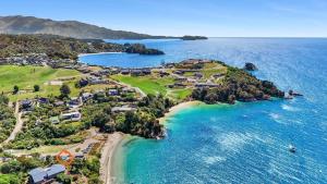 an aerial view of an island in the ocean at Seaside At Stephens Bay in Kaiteriteri