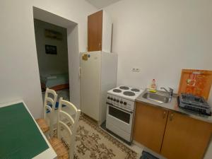 a kitchen with a stove and a sink and a refrigerator at Secret Garden Mostar in Mostar +18 photos