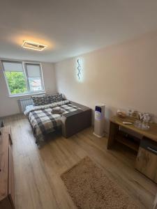 a bedroom with a bed and a table in it at U-Home in Verkhovyna