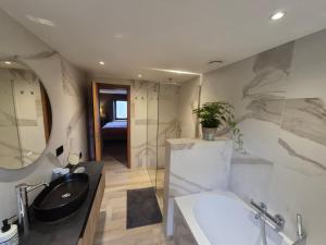 a bathroom with a sink and a bath tub at Le Petit Marcheloup in Paliseul +22 photos