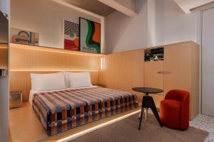 a hotel room with a bed and a chair at Dizengoff 99 by Isrotel Design in Tel Aviv +31 photos