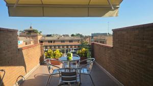 a patio with a table and chairs on a balcony at B&B dei nonni in Maranello