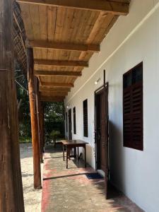 a porch with a table and a wooden ceiling at Warembo beach Nungwi in Nungwi +12 photos