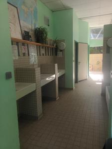 a room with green walls and a tile hallway at Grande caravane in Gergy