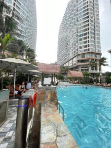 a swimming pool in a city with tall buildings at APEC Mandala in Mui Ne