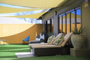 a patio with couches and plants on a building at EDEN BOUTIQUE HOTEL in Kokstad
