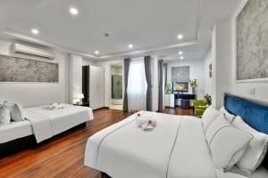 a bedroom with two beds and a couch at Golden Sun Hotel in Hanoi +47 photos