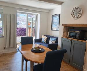 a living room with a dining room table and a couch at Dartmouth Diddy House in Dartmouth