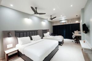 a hotel room with two beds and a desk at Hotel Lee Garden Near to Blue Flag Beach 500 Mtrs in Puri +82 photos