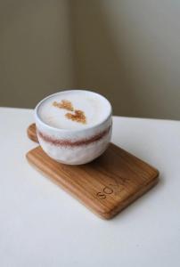 a white bowl sitting on a wooden board at Julie House Lombok in Ekas
