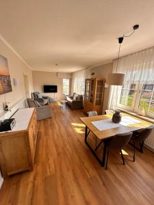 a living room with a couch and a table at Hotel-Pension Haus Hubertus in Borkum