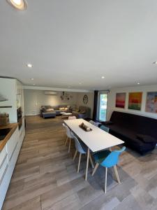 a large living room with a table and a couch at Les Coustelines Piscine privée et Jacuzzi in Forcalquier