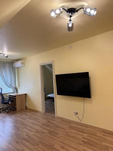 a living room with a flat screen tv on the wall at Guest house Kiev forest in Kyiv
