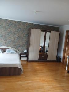 a bedroom with a bed and a large mirror at “Airīši” in Alūksne