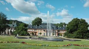a large building with a fountain in front of it at FeWo Dresden-Hellerau in Dresden