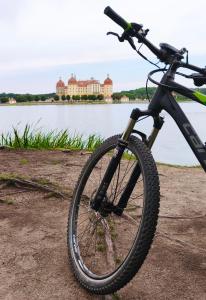 a bike parked next to a body of water at FeWo Dresden-Hellerau in Dresden