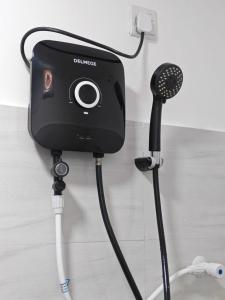 a camera hooked up to a wall with a microphone at Backpackers inn Hostel in Trincomalee