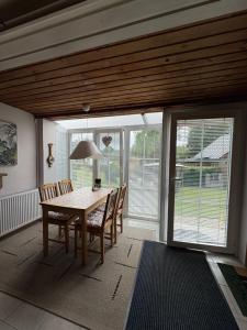 a dining room with a table and chairs and sliding glass doors at Privat Medo in Děpoltovice