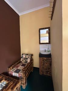 a small room with two beds and a sink at Balletto Boutique in Arusha +6 photos