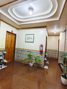 a room with potted plants and a ceiling at Mountain Lodge within Town Proper! in Sagada