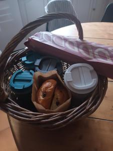 a basket with a bagel in it on a table at Les Murmures de la Forêt Bed and Breakfast in Lanas +11 photos
