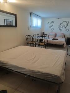 a room with two beds and chairs and a couch at L'Escapade Enchantée Paris-Disneyland in Noisy-le-Grand +31 photos