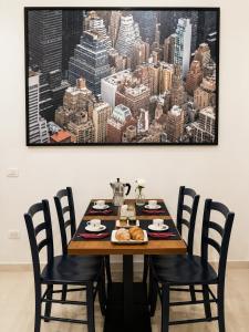 a dining room table with a picture of a city at RELAIS TORRE GLORIA in Naples