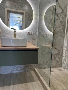a bathroom with a sink and a mirror at ЖК Модерн in Odesa