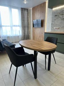 a wooden table and chairs in a room at ЖК Модерн in Odesa +4 photos