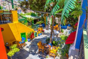 a view of a patio with colorful chairs and tables at Symi Garden Studios in Symi