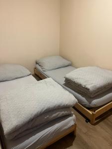 a room with three mattresses on beds in it at Rzeczny azyl in Pomiechówek