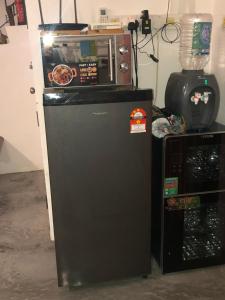 a microwave sitting on top of a refrigerator at Sugar Houz ruum2 in Johor Bahru