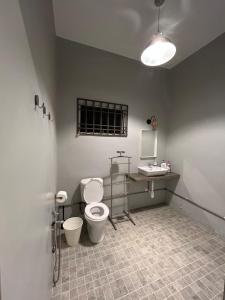 a bathroom with a toilet and a desk and a sink at Sugar Houz ruum2 in Johor Bahru