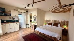 a bedroom with a large bed and a kitchen at The Jaffa Roof in Tel Aviv