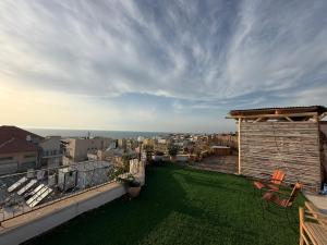 a balcony with a view of a city at The Jaffa Roof in Tel Aviv