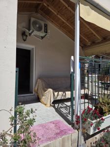 a room with a bed and a fan on a patio at Authentic Village House in Tourkolékas +2 photos