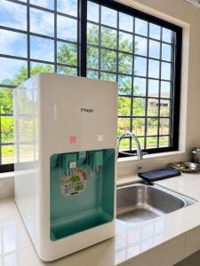 a machine sitting on a kitchen counter next to a sink at Kemaman AY Home in Cukai