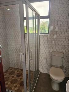 a bathroom with a toilet and a window at Nyanja Cottage in Chembe +8 photos